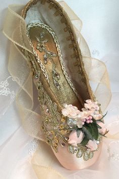 a close up of a ballerina shoe with flowers on it