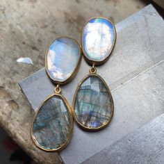 HANGING DOUBLE DROP EARRINGS, MOONSTONE, 16.5 CARAT, AND LABRADORITE, 15.76 CARAT SET IN 22K GOLD • DESIGNED AND HAND FORGED IN NEW YORK Please email info@elihalili.com or call the studio at 212-941-7979 for any inquiries Labradorite Earrings, Oval Earring, Moonstone Earrings, Ruby Sapphire, Ancient Coins, 22k Gold, Hand Forged, The Studio, Shop Necklaces