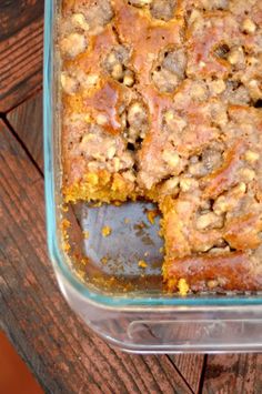 a casserole dish filled with food on top of a wooden table