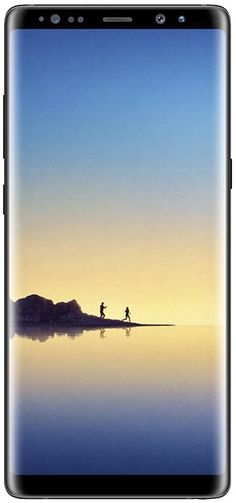 two people walking on the beach at sunset