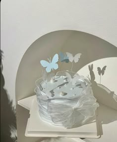 a white plate topped with butterflies on top of a table