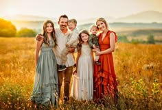 a family posing for a photo in a field