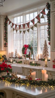 a kitchen decorated for christmas with candles and garland