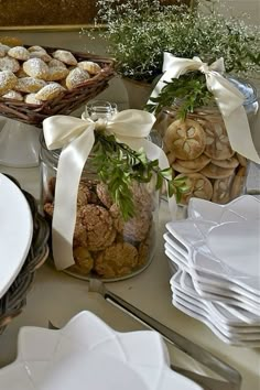 a table topped with lots of different types of food next to white plates and silverware