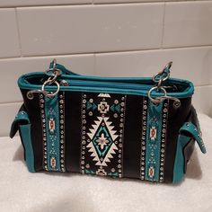 Montana West, Zippered Concealed Carry Pocket Satchel. Black And Turquoise Tribal Tapestry, Rhinestones And Studs All Intact. Multiple Pockets Inside And Out. Sturdy Leather Bag. Montana West Purse, Concealed Carry Purse, Fringe Handbags, Tooled Leather Purse, Embroidered Tote, Leather Satchel Handbags, Leather Fringe, Satchel Handbags, Shoulder Purse