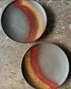 two bowls with red and yellow speckles on them