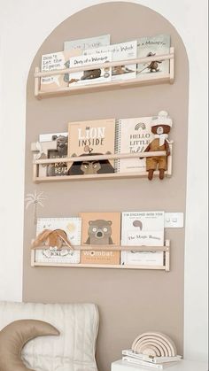 two wooden shelves with books on them and a chair in front of one that has a stuffed animal