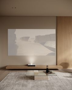 a living room with a large screen on the wall and coffee table in front of it