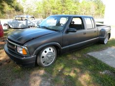 a black pickup truck parked in the grass