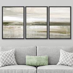 three paintings hanging on the wall above a couch