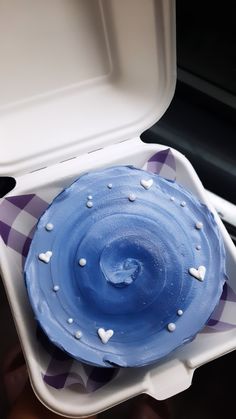 a blue cake in a white plastic container