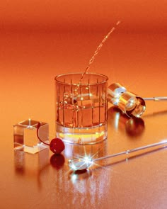 a glass filled with liquid sitting on top of a table next to two small objects