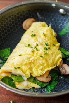 an omelet with mushrooms and greens in a bowl