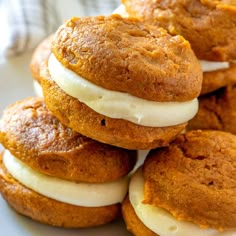 a white plate topped with cookies covered in frosting and pumpkin pie filling on top of each other