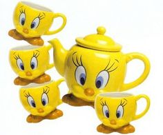 a yellow tea set with four cups and two saucers, one has an angry face on it