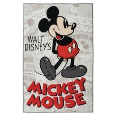 a mickey mouse poster hanging from the side of a white wall with words on it