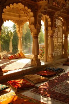 the sun shines through an open room with many rugs on the floor