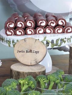 there are some chocolates and broccoli on the cake stand with other treats