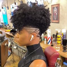 Check out 40 Simple and edgy tapered haircuts for women perfect for any natural hair texture. Frohawk Natural Hair Short, Lesbian Haircut For Black Women, Faded Hairstyles For Black Women, Short Sides Long Top Hair Women Black Natural, Afro With Shaved Sides, Natural Undercut Hairstyles Black Women, Black Women Tapered Natural Hair, Black Woman Natural Haircut, Women’s Tapered Haircut