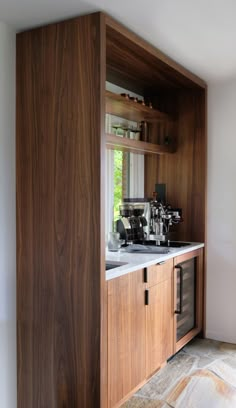 a kitchen with wooden cabinets and white counter tops