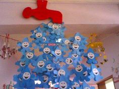 a bunch of blue stuffed animals hanging from the ceiling in a room with other decorations