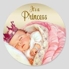 a round sticker with a baby wearing a tiara