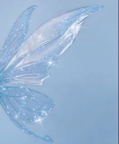 a blue butterfly flying in the air with its wings spread out and sparkling on it's back