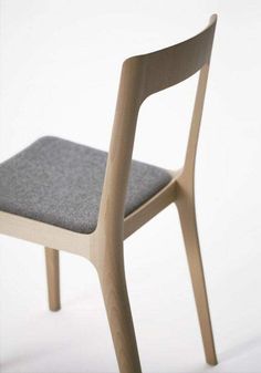 a wooden chair with a gray seat cushion on it's backrest and side view