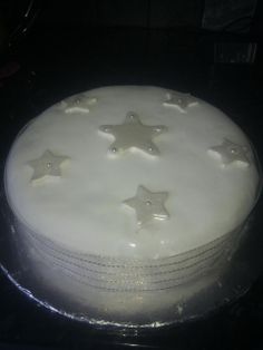 a cake with white frosting and stars on it