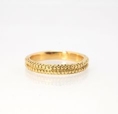 This is cast from a granulated original and is pictured in 14k yellow gold, but I can also cast this in Sterling or 18k yellow. Or would be happy to make a similar design for you in original 18k granulation!Granulation is a controlled fusing process that has been utilized for thousands of years. This unique surface will get more interesting with wear. The granules are individually placed and fused with a mouth torch. I then make a mold of the ring and pull a wax copy from that mold and cast it u Classic 22k Gold Ceremonial Jewelry, 14k Yellow Gold Hammered Jewelry, Hammered 14k Yellow Gold Jewelry, Hand Forged Yellow Gold Round Band, Ceremonial Heirloom Yellow Gold Jewelry, Ceremonial Diamond Cut Gold Jewelry, Ceremonial Yellow Gold Diamond Cut Jewelry, 14k Stamped Yellow Gold Nugget Jewelry, Heirloom Hand Forged Yellow Gold Jewelry