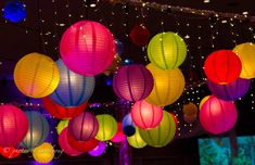 many colorful lanterns are hanging from the ceiling