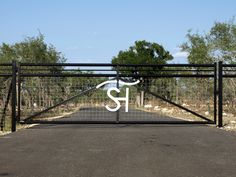 an iron gate with the letter s on it