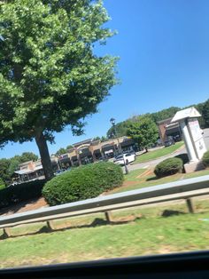 the view from inside a car looking out at a street with cars parked on it