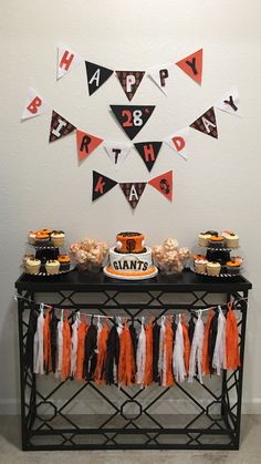 an orange and black birthday party with decorations