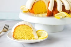 a bundt cake with lemon and icing on a plate next to a fork