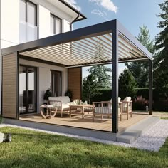 a patio covered in furniture and grass next to a house