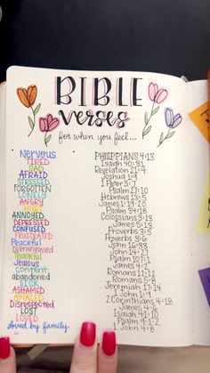 the bible verse book is open and has writing on it with colorful flowers around it