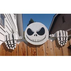 a wooden fence with a skeleton painted on it