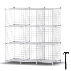 a white wire shelving unit with six shelves and two hammers on the floor