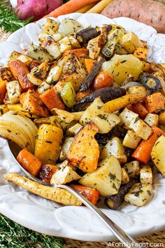 a white plate topped with potatoes and carrots