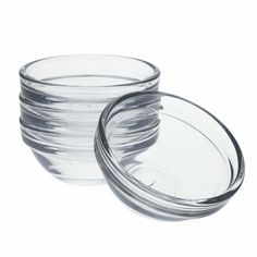 clear glass bowls stacked on top of each other with lids in front of white background