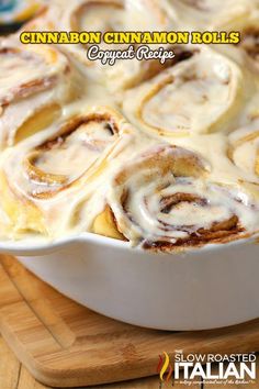 cinnamon roll recipe in a white dish on a cutting board