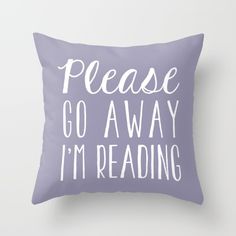 a purple pillow with the words please go away i'm reading printed on it