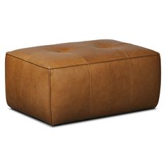 a brown leather ottoman sitting on top of a white floor