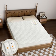 an image of a bed with two remote controls on it