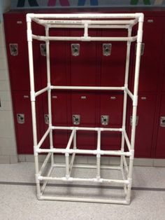 a white metal rack in front of red lockers