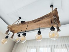 the light bulbs are hanging from the wooden beam