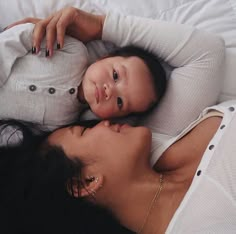 a woman and child laying on top of each other