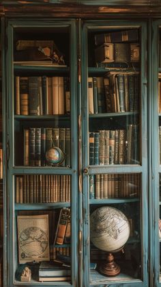 an old bookcase filled with lots of books next to a globe and other items