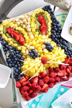 a plate filled with fruit on top of a table next to plates of desserts